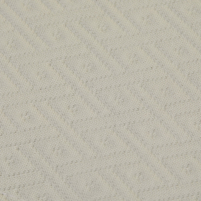 A detailed view of the top fabric on the Slumber Cloud Core Mattress Protector - Crib