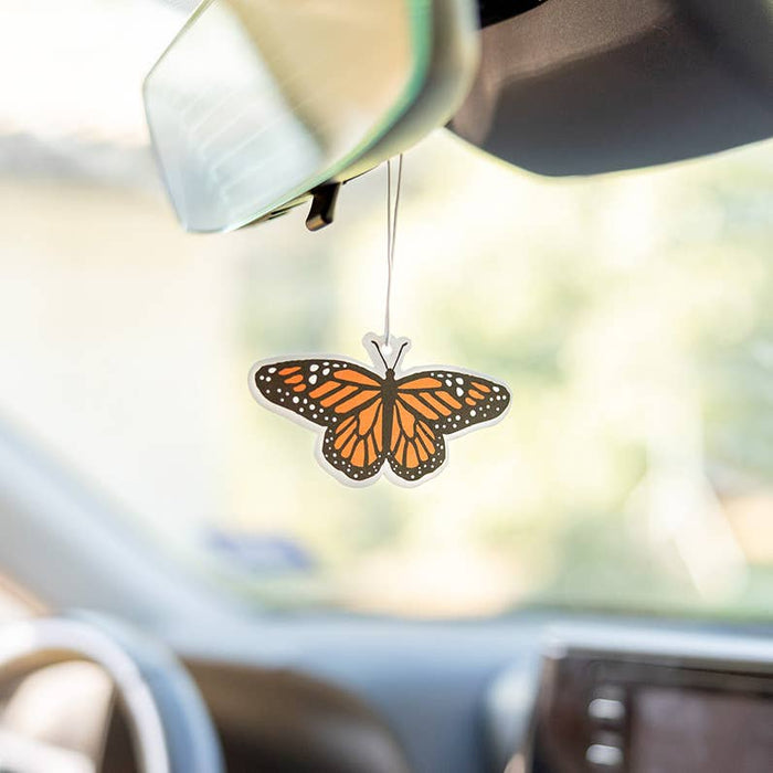 Forager Provisions LTD monarch butterfly air freshener hanging from a car rearview mirror with lavender scent