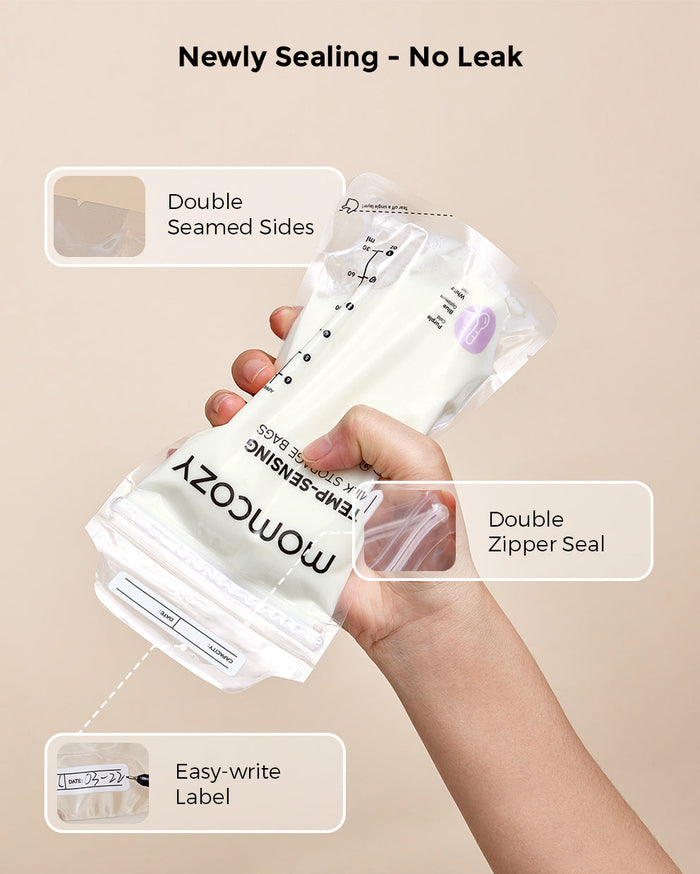 Hand holding Momcozy breastmilk storage bag showing features like double seamed sides, double zipper seal, and easy-write label. Text reads 'Newly Sealing - No Leak'.