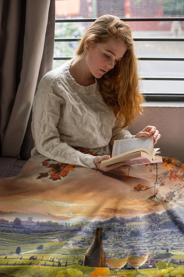Woman reading a book with a scenic overlay of a vineyard and sunset in Chianti, Tuscany blanket.