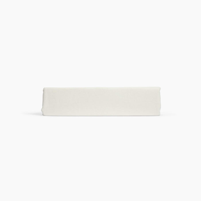 Avec linen classic top sheet in bone folded neatly on a white background