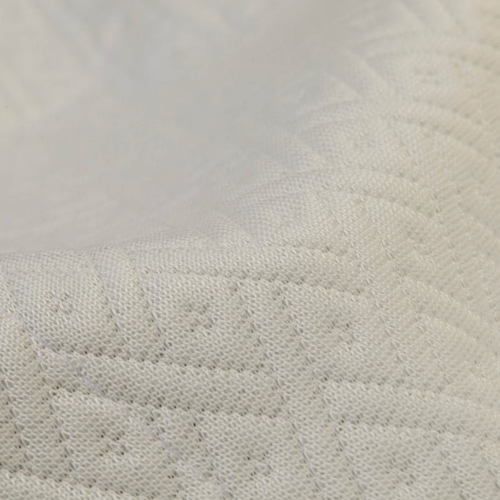 A detailed view of the top fabric on the Slumber Cloud Core Mattress Protector - Crib