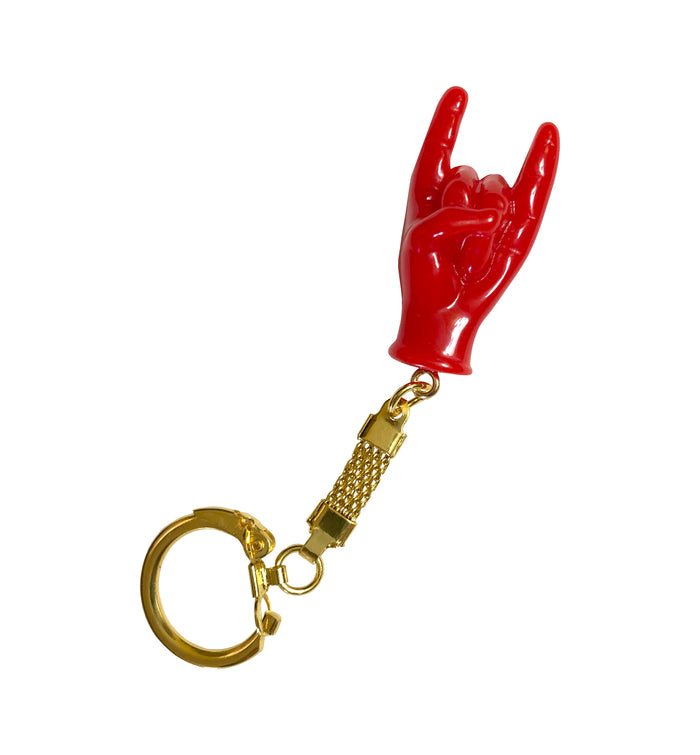 Red hand-shaped keychain making the “rock on” gesture, attached to a gold-colored chain and keyring. The glossy charm blends Italian Malocchio symbolism with rock culture, serving as a bold accessory for protection, style, or gifting.