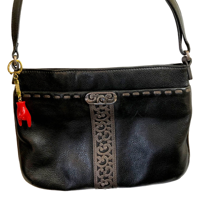 Red hand-shaped keychain making the “rock on” gesture, attached to a gold-colored chain and keyring on a bag. The glossy charm blends Italian Malocchio symbolism with rock culture, serving as a bold accessory for protection, style, or gifting.