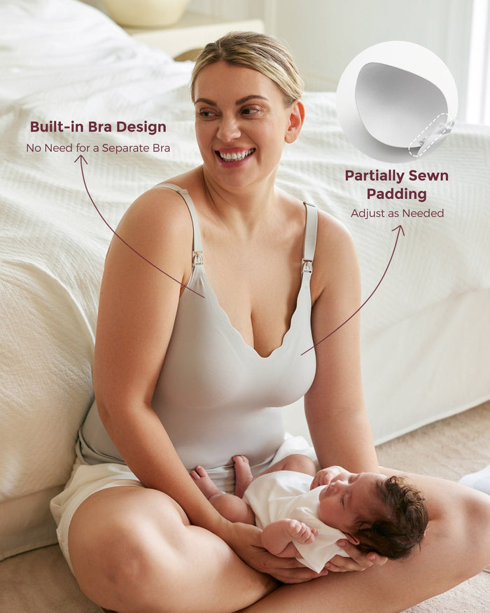 Mom in grey Maternity Nursing & Pumping Tank Top with built-in bra and partially sewn padding, breastfeeding.