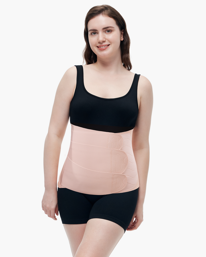 Momcozy Ergowrap Postpartum Belly Band in oyster pink color, worn by a woman, adjustable straps, postpartum support.