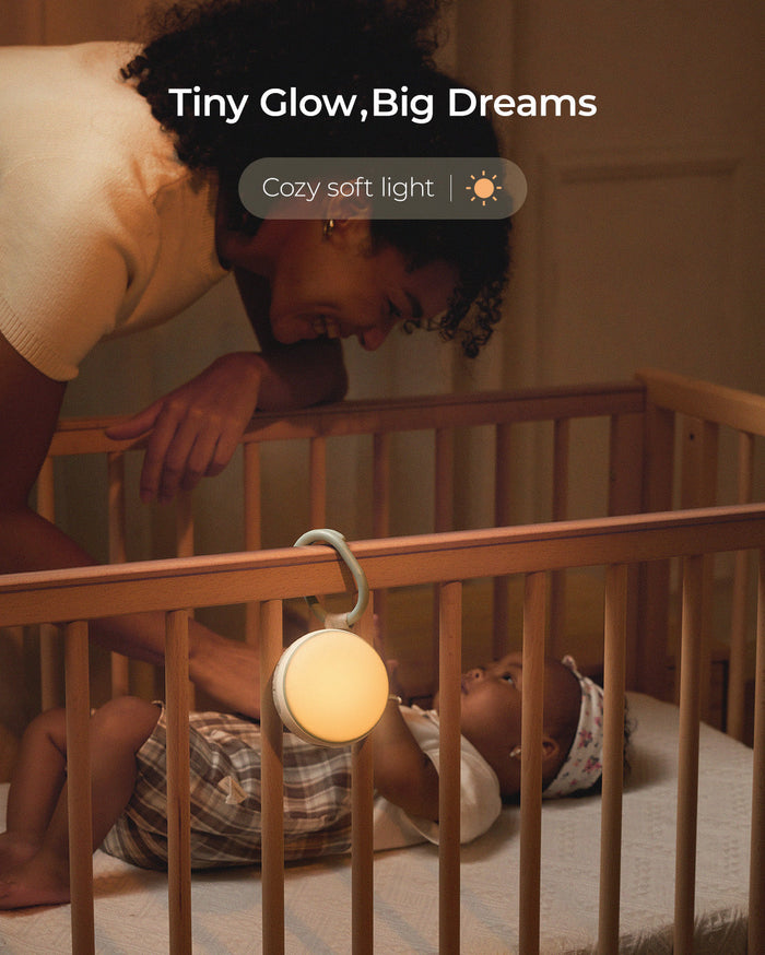 Momcozy portable sound machine with soft, warm light, promoting Tiny Glow, Big Dreams. Soft light and sounds to soothe baby.