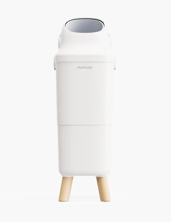 A white tall bin named momcozy is in the center with four beige legs and an opening on top, the background is white.