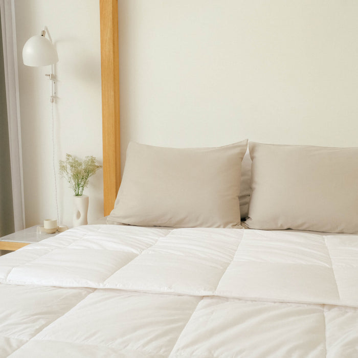 A clean bedroom with Slumber Cloud Comforter and pillows