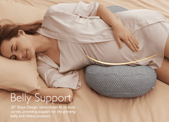 Pregnant woman resting on a Pregnancy Wedge Pillow with Cooling Cover for belly support.