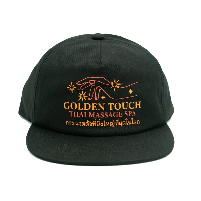 A black unstructured cap with a text logo on the front that reads 'Golden Touch Thai Massage Spa' in orange and white.