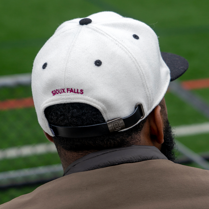 the back of a guy wearing sioux falls city fc hat