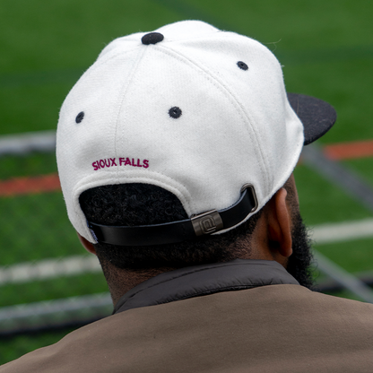 the back of a guy wearing sioux falls city fc hat