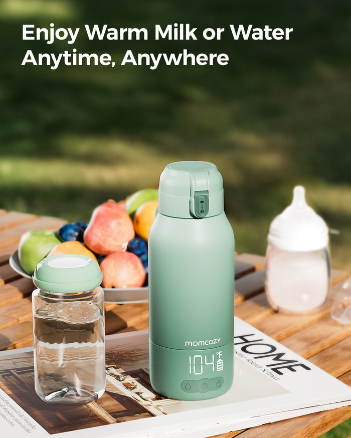 Momcozy portable breast milk and water warmer in mint green, LCD display, ideal for travel and quick warming of milk.