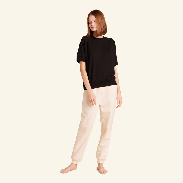 Woman wearing the Slumber Cloud Essential Raglan Pullover made with Outlast temperature regulation technology