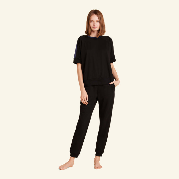 Woman wearing the Slumber Cloud Essential Raglan Pullover made with Outlast temperature regulation technology