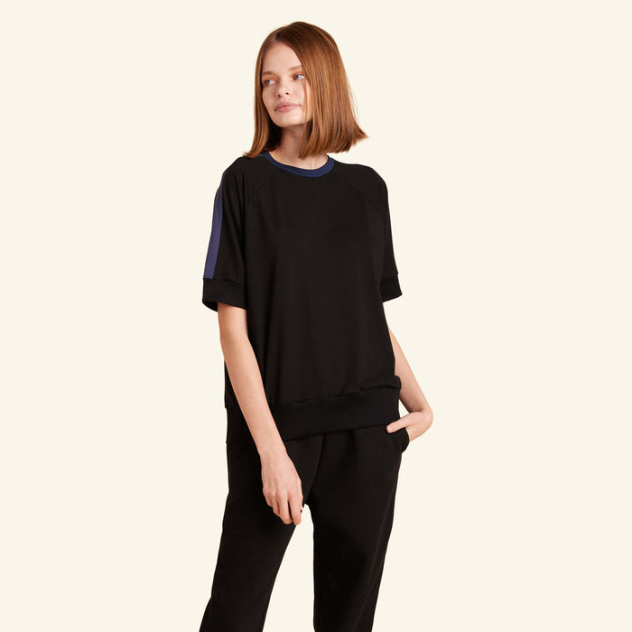 Woman wearing the Slumber Cloud Essential Raglan Pullover made with Outlast temperature regulation technology